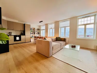 a living room with a couch and a table at Central apartment in Trondheim in Trondheim