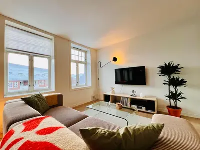a living room with a couch and a tv at Central apartment in Trondheim in Trondheim