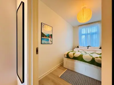a small bedroom with a bed and a window at Central apartment in Trondheim in Trondheim