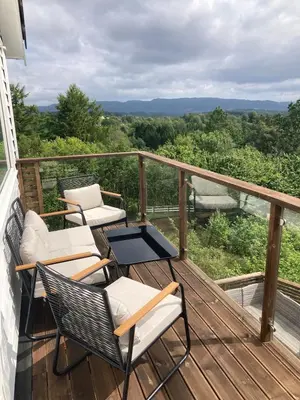 a balcony with chairs and a table and a view at Duplex near airport in Bergen
