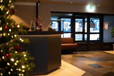 a christmas tree in the lobby of a office at Elvehagen Hotell in Sande