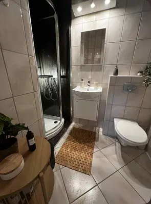 a bathroom with a toilet and a shower and a sink at Koselig leilighet med utsikt, gåavstand fra sentrum in Stord