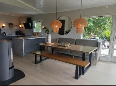 a kitchen and living room with a table and couch at Villa Varden 10 min from Bergen sentrum in Bergen