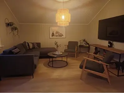 a living room with a couch and a tv at Villa Varden 10 min from Bergen sentrum in Bergen