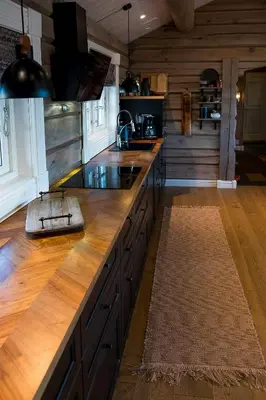 a kitchen with a wooden counter top with a sink at Tømmerhytte Med Utsikt Over Jotunheimen in Gålå