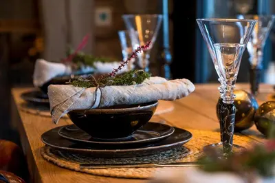 a table with a bowl of food and a glass at Tømmerhytte Med Utsikt Over Jotunheimen in Gålå