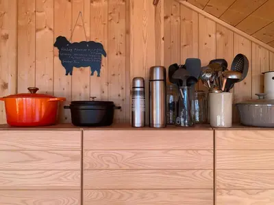 a shelf with utensils on a wooden wall at Modern Cabin With Views Of Hallingskarvet in Torpo