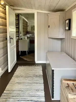 a room with a door and a room with a table at Log Cabin With Views Of Rondane Mountains in Folldal