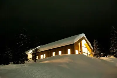 a building with snow on the side of it at Modern Family Cabin With Trysil Mountain Views in Trysil