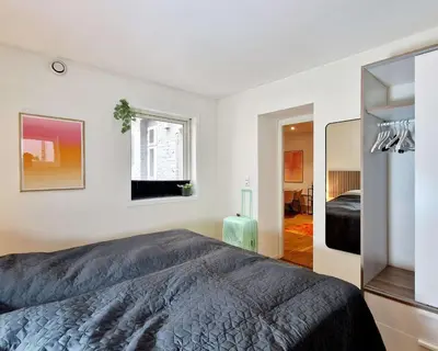 a bedroom with a large bed and a window at Prime location amazing king bed colorful oasis in Bergen