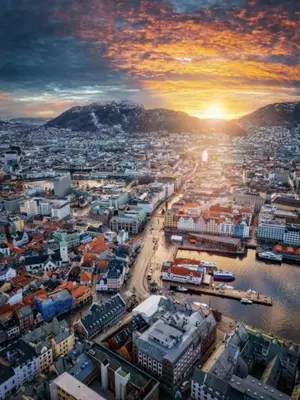 a view of a city with the sunset in the background at Prime location amazing king bed colorful oasis in Bergen