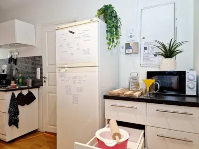 a kitchen with a white refrigerator and a microwave at Prime location amazing king bed colorful oasis in Bergen