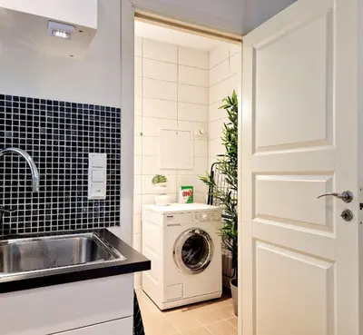 a kitchen with a washing machine and a sink at Prime location amazing king bed colorful oasis in Bergen