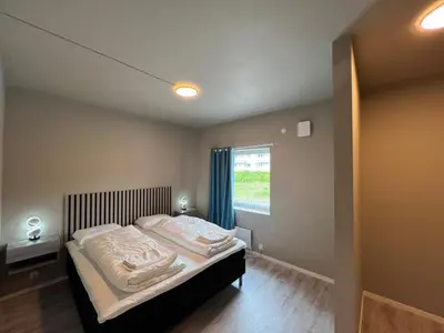 a bedroom with a bed and a window at Åndalsnes House---Apartments in Åndalsnes