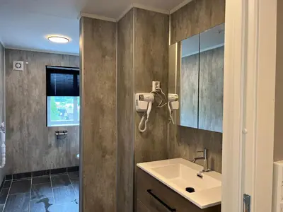 a bathroom with a sink and a mirror at Åndalsnes House---Apartments in Åndalsnes