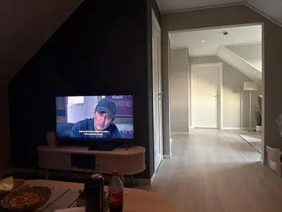 a flat screen tv sitting in a living room at Cozy house on Gryttingshaugen, near Vinstra in Sør-Fron