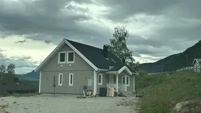 a small house in the middle of a field at Cozy house on Gryttingshaugen, near Vinstra in Sør-Fron
