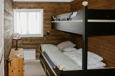 a bedroom with two bunk beds and a window at Modern Family Cabin With Views Of Spåtind in Etnedal