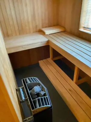 an inside view of a sauna with a bench and a suitcase at Modern Family Cabin With Views Of Spåtind in Etnedal