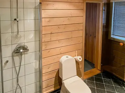 a bathroom with a white toilet and a shower at Modern Family Cabin With Views Of Spåtind in Etnedal