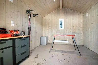 a room with a table in the middle of a house at Magiske Vinterdage I Sjusjøen in Mesnali