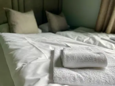 a white towel sitting on top of a bed at Gausta Sportell in Gaustablikk
