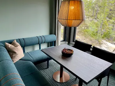 a living room with a table and a couch at Gausta Sportell in Gaustablikk