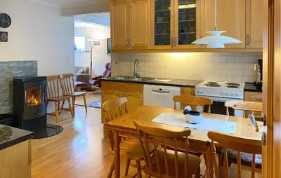 a kitchen and dining room with a table and a fireplace at Awesome Home In Åheim With Wifi in Åheim