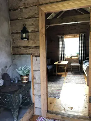 a room in a wooden cabin with a wooden door at Stall Rygg Mountain Cottage, Gloppen