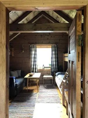 a room with a couch and a table in a room at Stall Rygg Mountain Cottage, Gloppen