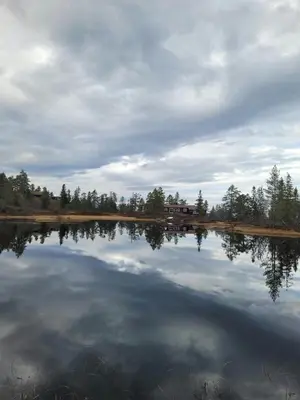 a large body of water with a house in the background at Modern Cabin At Blefjell in Svene