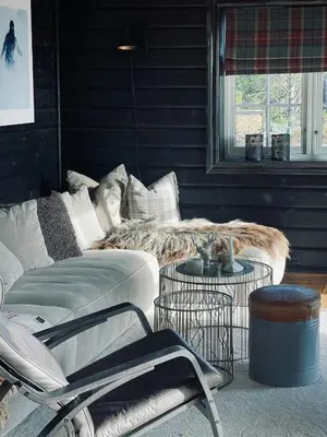 a living room with a couch and two tables at Spacious Family Cabin In Western Golsfjellet in Gol