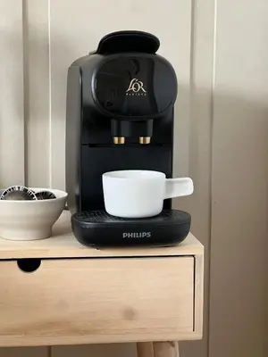 a coffee maker sitting on top of a table at Leilighet nær Color Line i Larvik in Lii