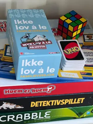 a stack of books sitting on a table at Leilighet nær Color Line i Larvik in Lii