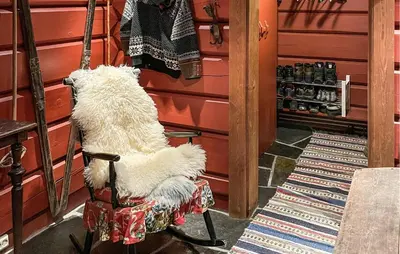 a white dog sitting in a chair in a store at 4 Bedroom Gorgeous Home In Hovden I Setesdal in Hovden