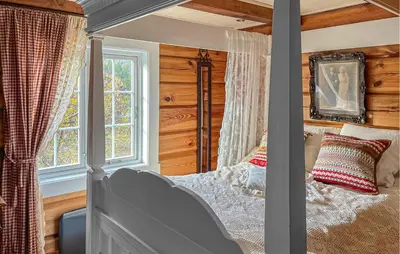 a bedroom with a bed and a window at 4 Bedroom Gorgeous Home In Hovden I Setesdal in Hovden