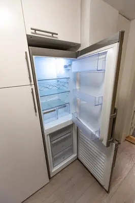 an empty refrigerator with its door open in a kitchen at Kozy apartment near Bergen city center with free parking and Wifi in Bergen