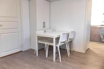 a white table and chairs in a room at Kozy apartment near Bergen city center with free parking and Wifi in Bergen