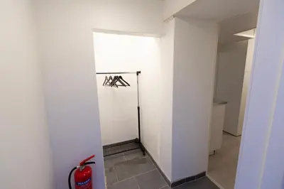 a room with a white wall and a fire extinguisher at Kozy apartment near Bergen city center with free parking and Wifi in Bergen