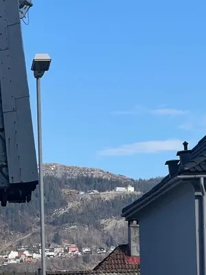 a street light with a mountain in the background at Kozy apartment near Bergen city center with free parking and Wifi in Bergen