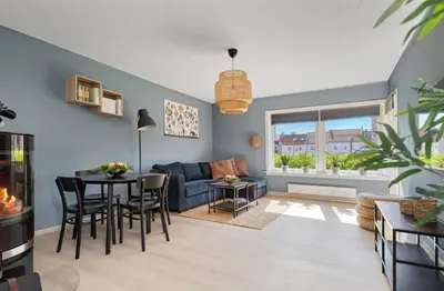 a living room with a couch and a table at Great Downtown Apartment in Lii