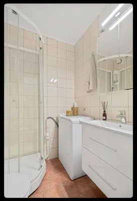 a bathroom with a shower and a sink and a toilet at Great Downtown Apartment in Lii