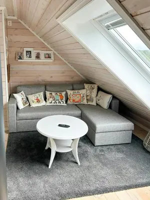 a living room with a couch and a table at Cabin With Sea Views In Mjømna