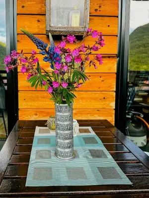 a vase filled with flowers sitting on a table at Mountain Apartment With Views In Myrkdalen in Vossestrand