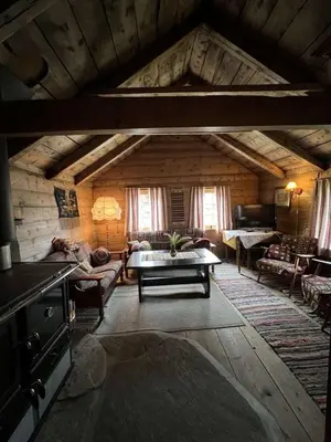 a living room with a couch and a table at Gamlestova in Viksdalen