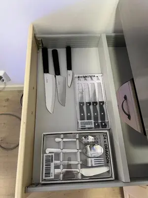 a box with knives and utensils in it at Cozy and modern studio house in Trondheim