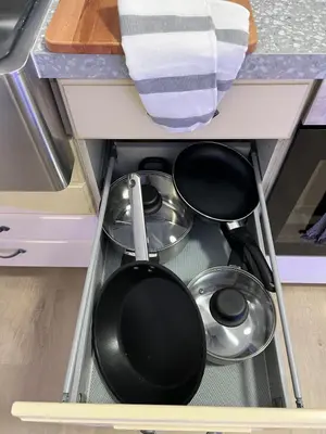 a drawer with pots and pans in a kitchen at Cozy and modern studio house in Trondheim