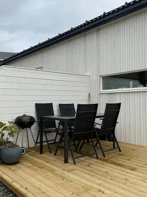 a black table and chairs on a patio at New Modern House by the Sea in Askøy
