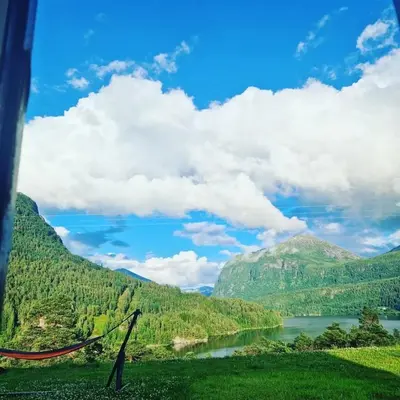 a view of a river with mountains in the background at Idyllic house with views - close to nature in Nydalen