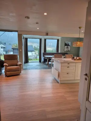 a large living room with a kitchen and a piano at Idyllic house with views - close to nature in Nydalen
